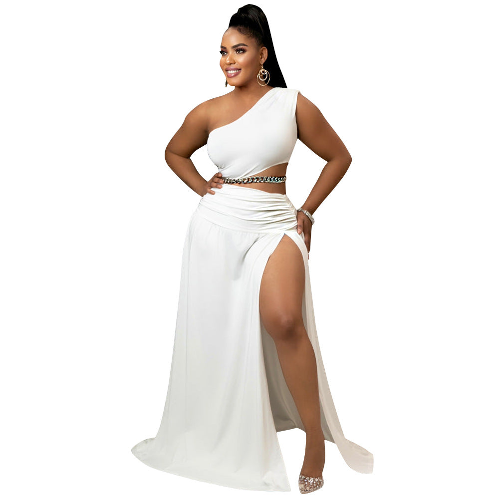 Woman wearing a white one-shoulder dress with a high slit on a white background