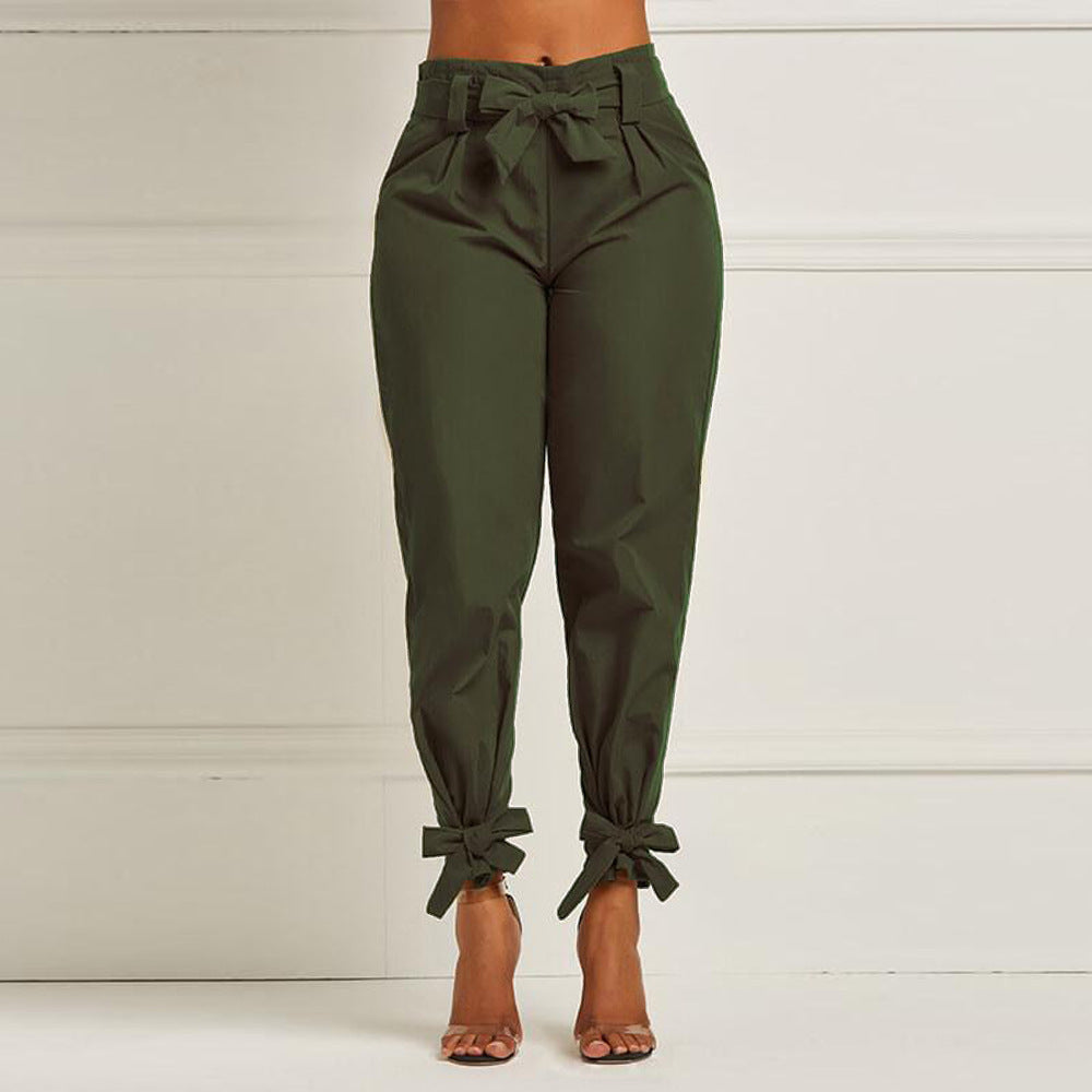 Green pants with tied cuffs on a white background
