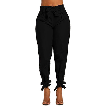 Black pants with tied bow cuffs on a white background