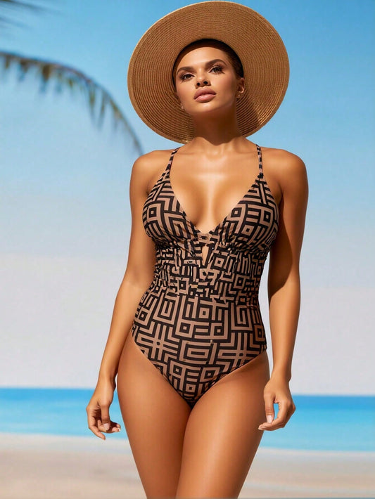 Women's brown geometric print one-piece swimsuit with deep V-neck and keyhole detail, beach lifestyle shot – Blutiful

