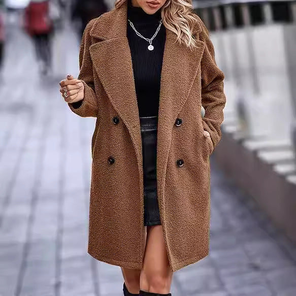 Woman wearing a brown coat on a blurred street background