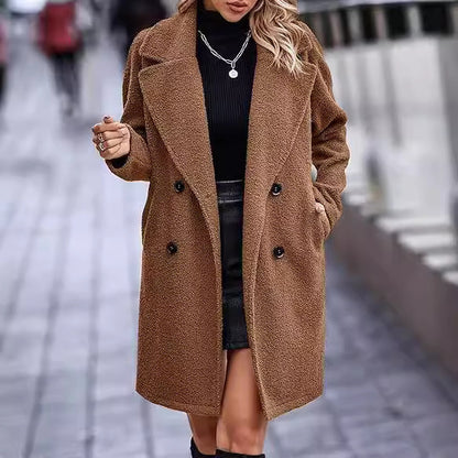 Woman wearing a brown coat on a blurred street background