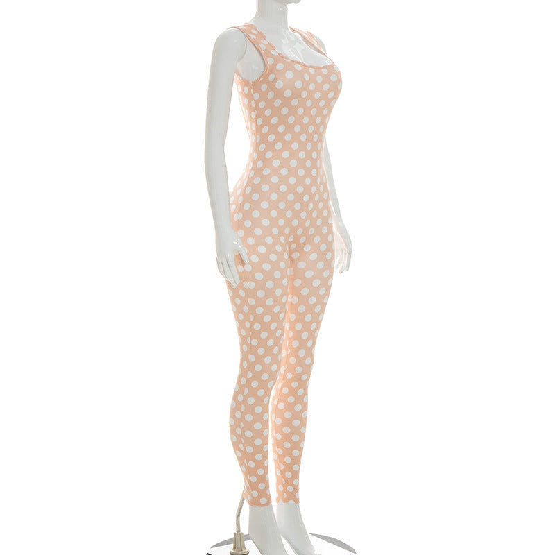 Side view of the champagne polka-dot jumpsuit on a mannequin showing the square neckline and wide-leg trouser silhouette